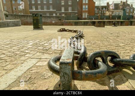 Old chains laying on the walkway to remind us of Kings Lynn`s heritage. Stock Photo